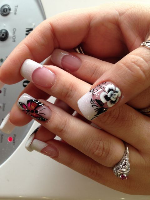 White French tips with hand-painted butterfly and white flower accents