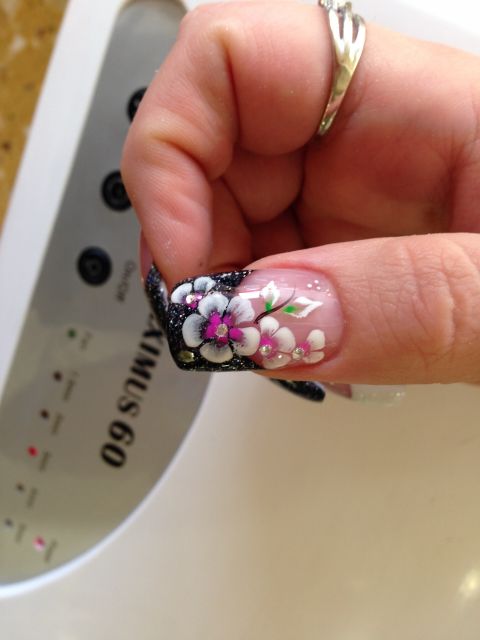 Black glitter French tip with a hand-painted white and pink flower