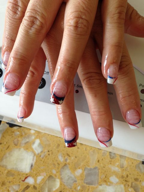 Red, white and blue swirl French tips with a glitter star accent nail