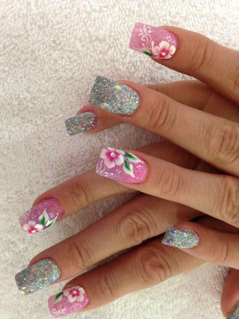 Pink and silver glitter acrylics with hand-painted white flowers